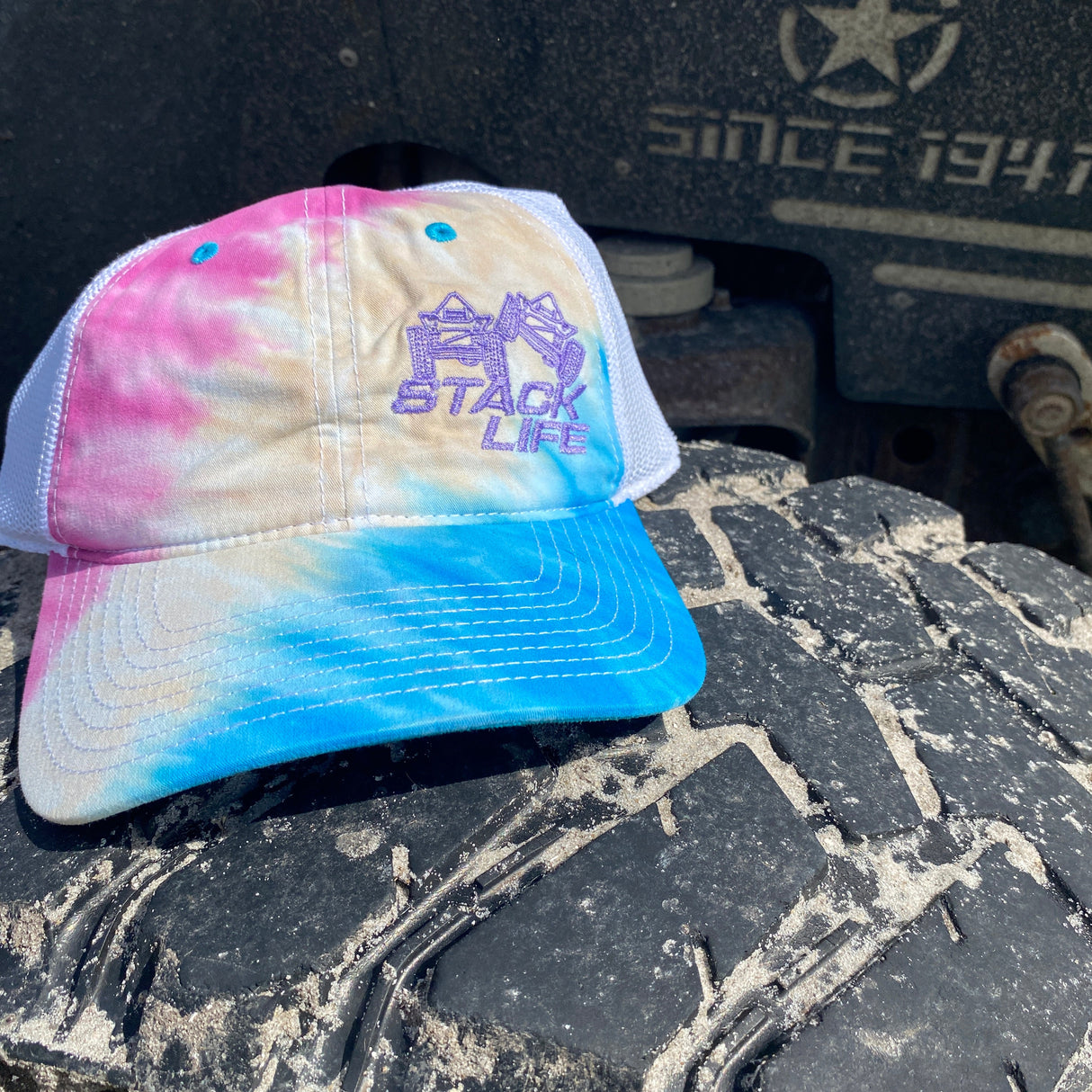 pink blue tie dyed stack life trucker hat with purple logo