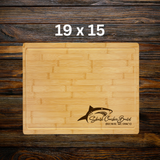 Wooden cutting board with shark logo and text on a wooden background
