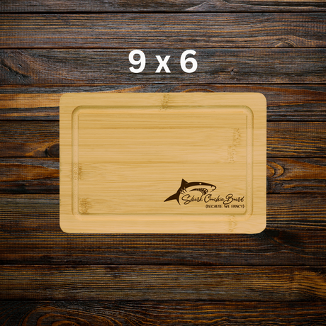 Wooden cutting board with shark logo on a wooden background