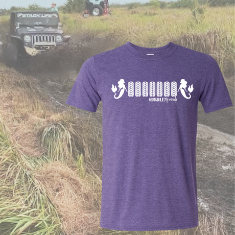Purple t-shirt with white 7 tire design and mermaids on each side graphic design on a background of an off-road vehicle in a field.