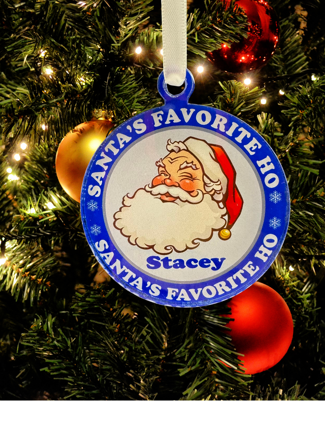 
Vintage-style acrylic Christmas ornament featuring a winking Santa, the text "Santa's Favorite Ho," and a customizable name in festive colors, hanging on a tree.