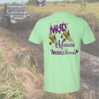 Mint t-shirt with 'Mud & Mascara' text in a muddy field with off-road vehicle.