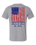 Light grey t shirts with american flag on the back running vertical down back.  At the bottom of the flag is a stack of 7 off road vehicles with the words Stackin' to honor the fallen underneath