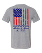 Light grey t shirts with american flag on the back running vertical down back.  At the bottom of the flag is a stack of 7 off road vehicles with the words Stackin' to honor the fallen underneath
