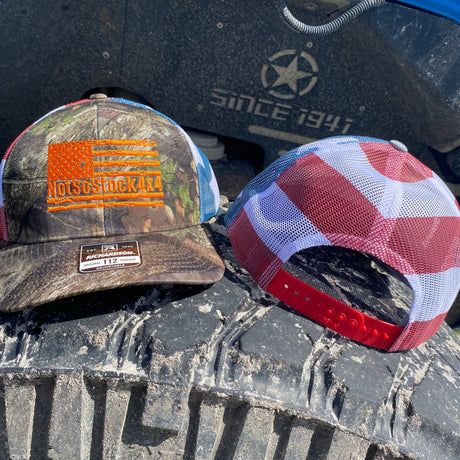 front back view of american flag camo trucker hat with oragne notsostock 4x4 on front