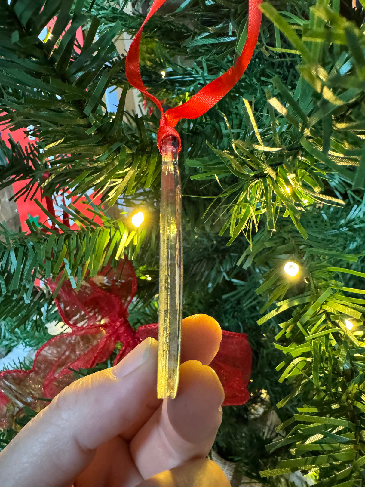 Vintage-style acrylic Christmas ornament featuring a winking Santa, the text "Santa's Favorite Ho," and a customizable name in festive colors, hanging on a tree.