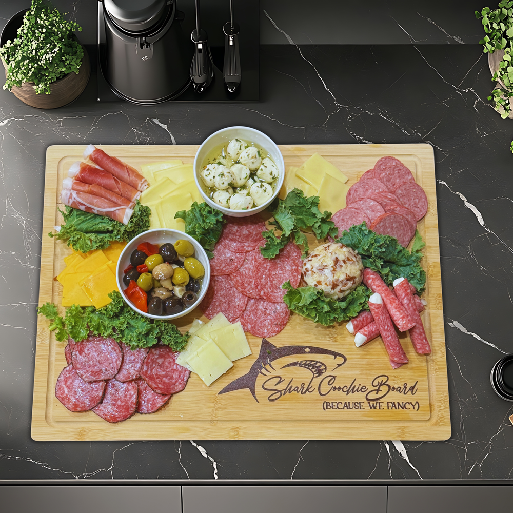 Wooden charcuterie board with sliced meats, cheeses, and vegetables on a dark marble countertop.