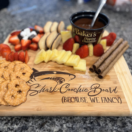 Image of 2 tone bamboo board with a shark and the words Shark Coochie Board, because we fancy in script. 